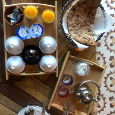 a wooden table topped with plates of food