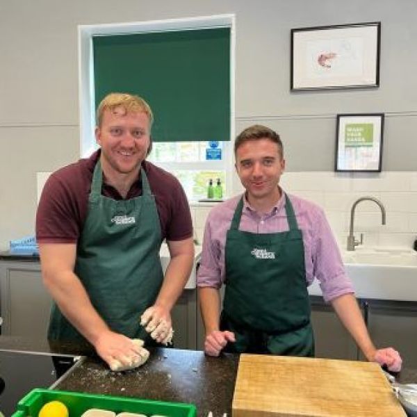 two people standing in a kitchen
