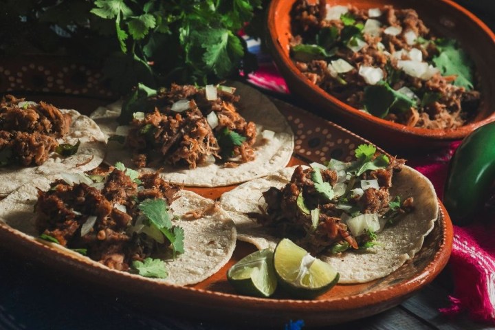 a bowl of mexican street food on a table