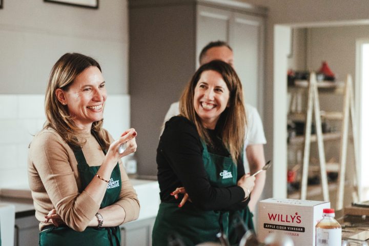 a group of people in the kitchen posing for the camera