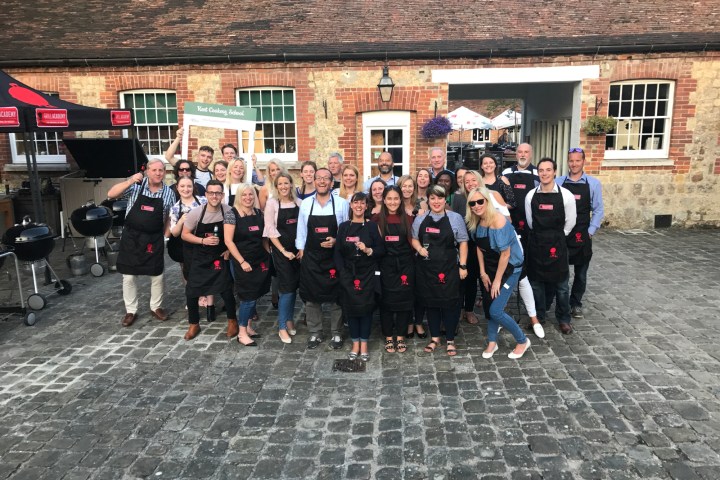 a group of people standing in front of a brick building