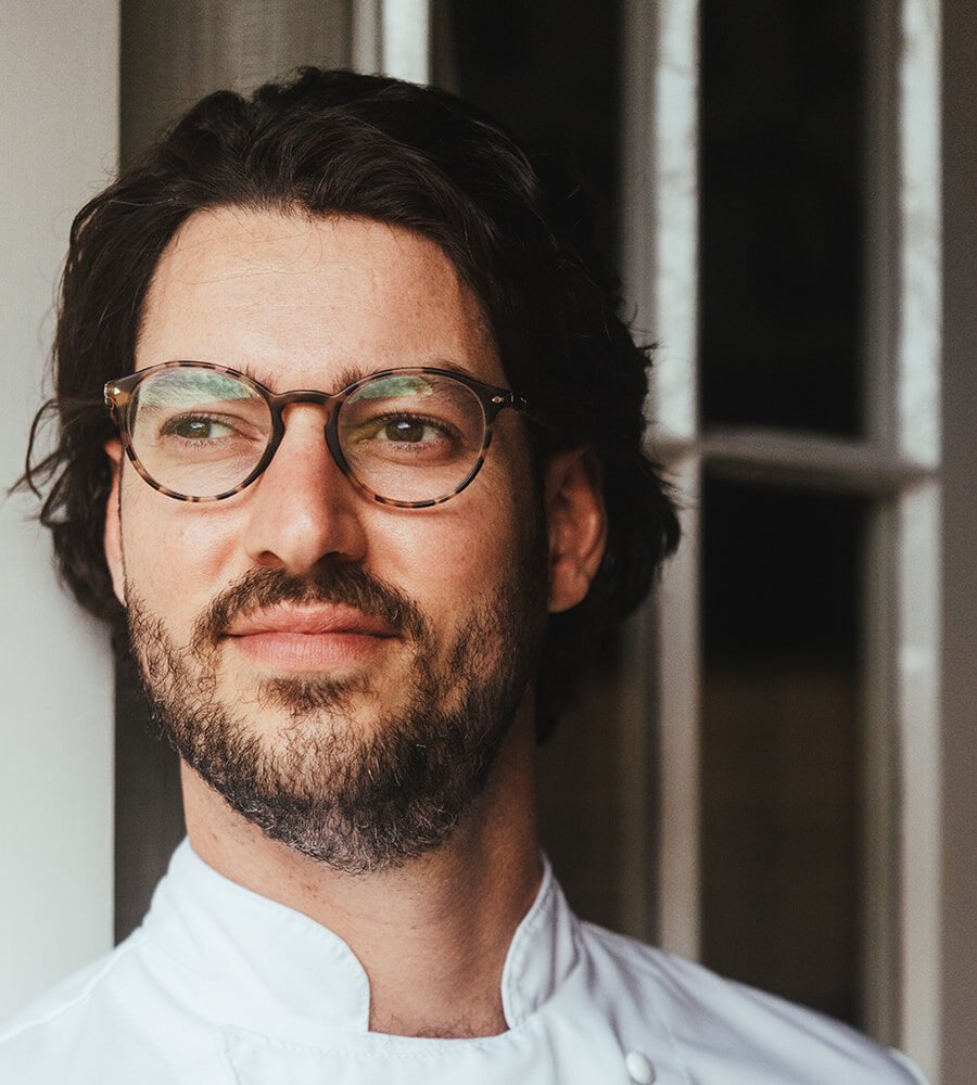a man wearing glasses and looking at the camera