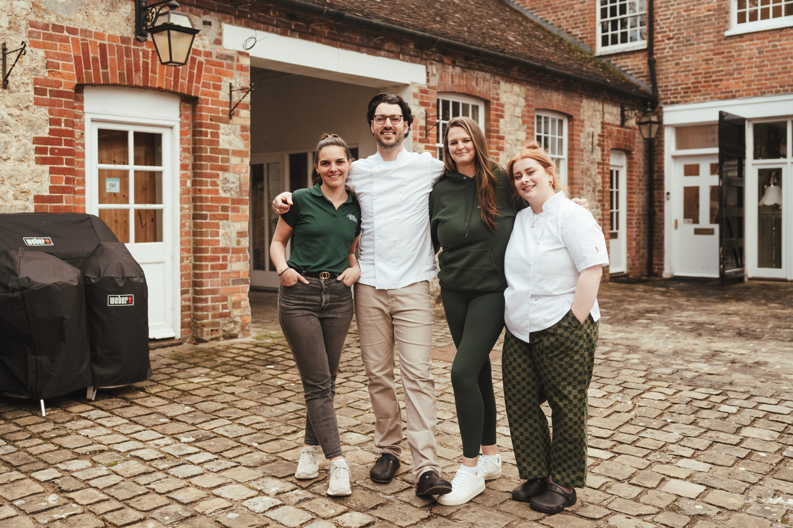 a group of people standing in front of a brick building